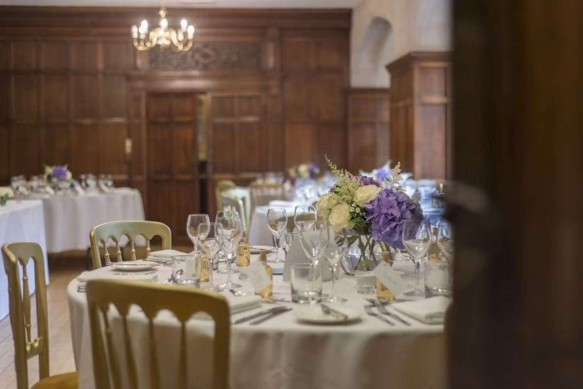 A wedding breakfast in a wood-panelled room at Lanwades Hall