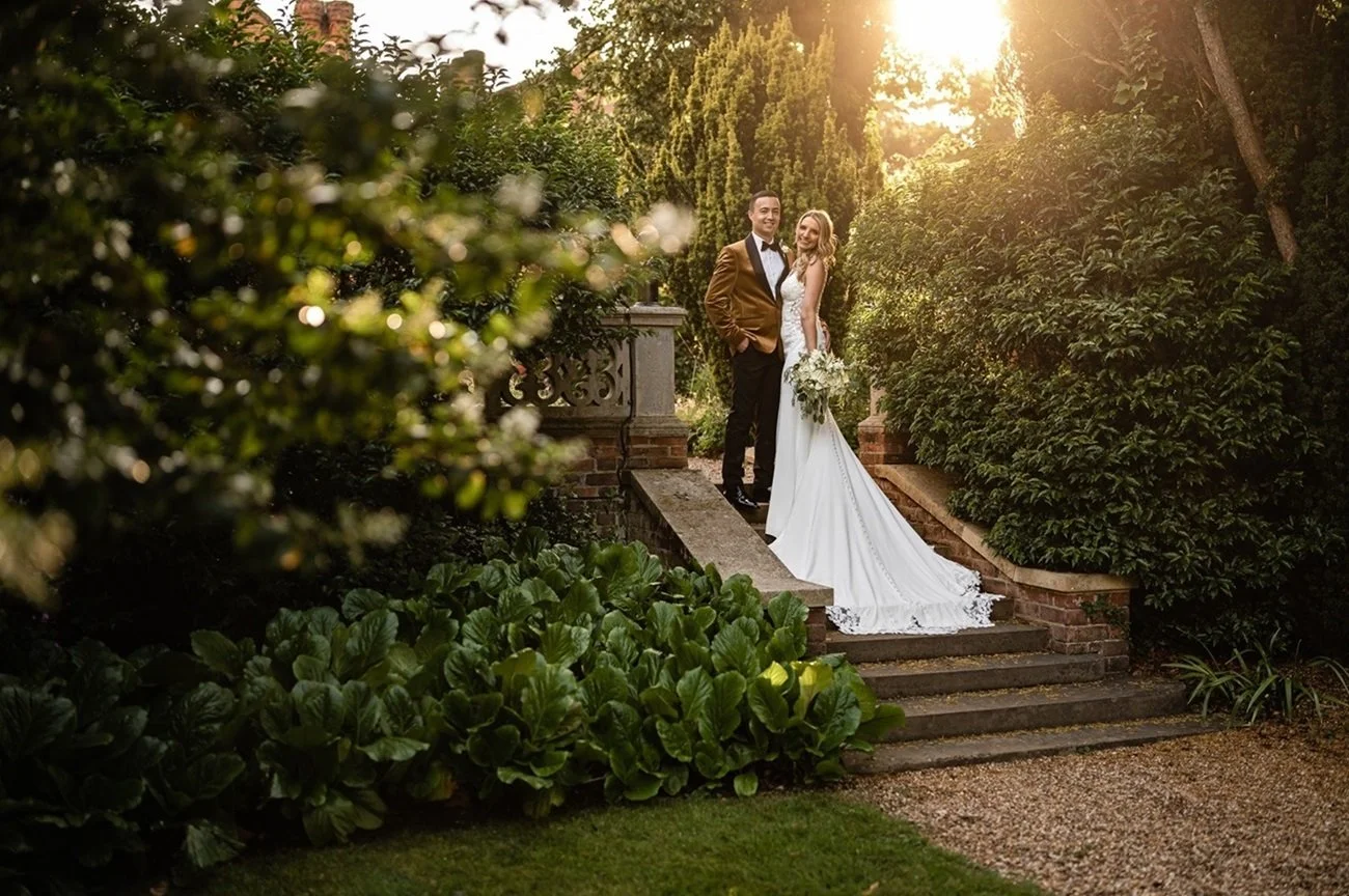 A couple at golden hour in the gardens at Lanwades Hall