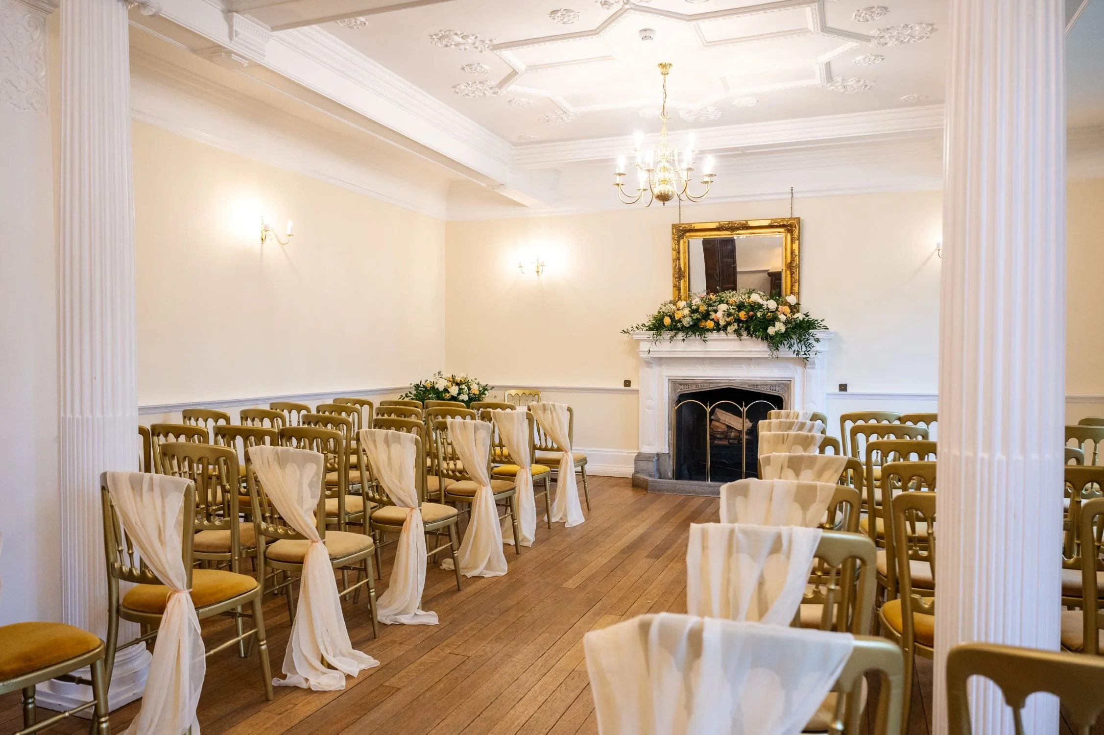 An indoor ceremony by the fireplace at Lanwades Hall