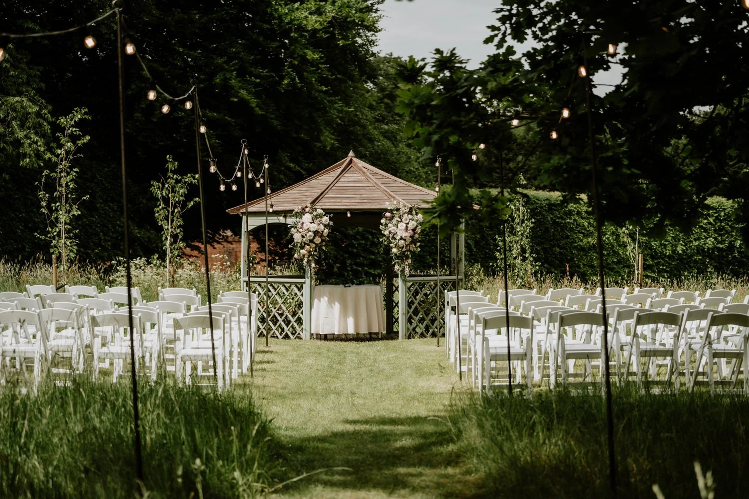 Outdoor meadow orchard wedding ceremony setup at Lanwades Hall