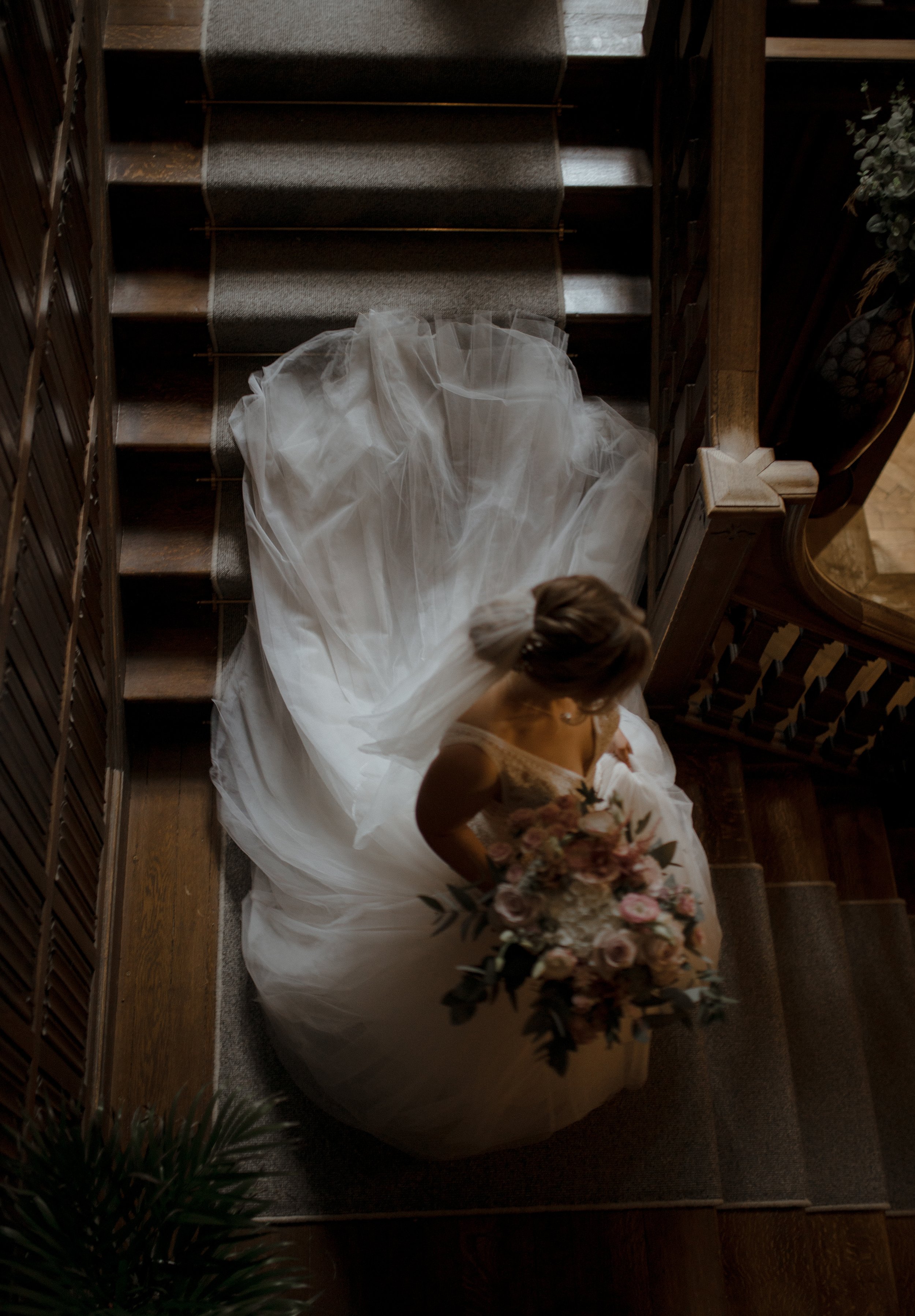 A bride on the staircase at Lanwades Hall
