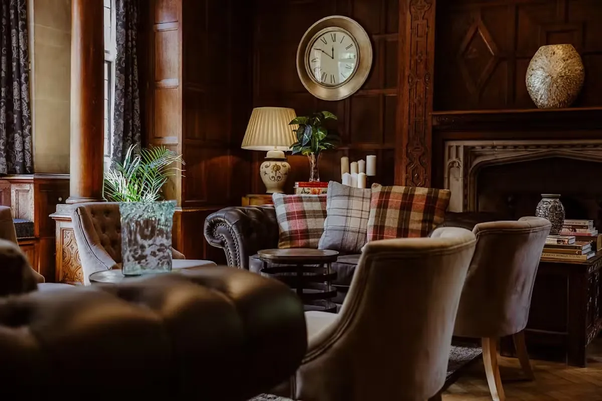 The Drawing Room (bar) at Lanwades Hall, with leather sofas and an open fire