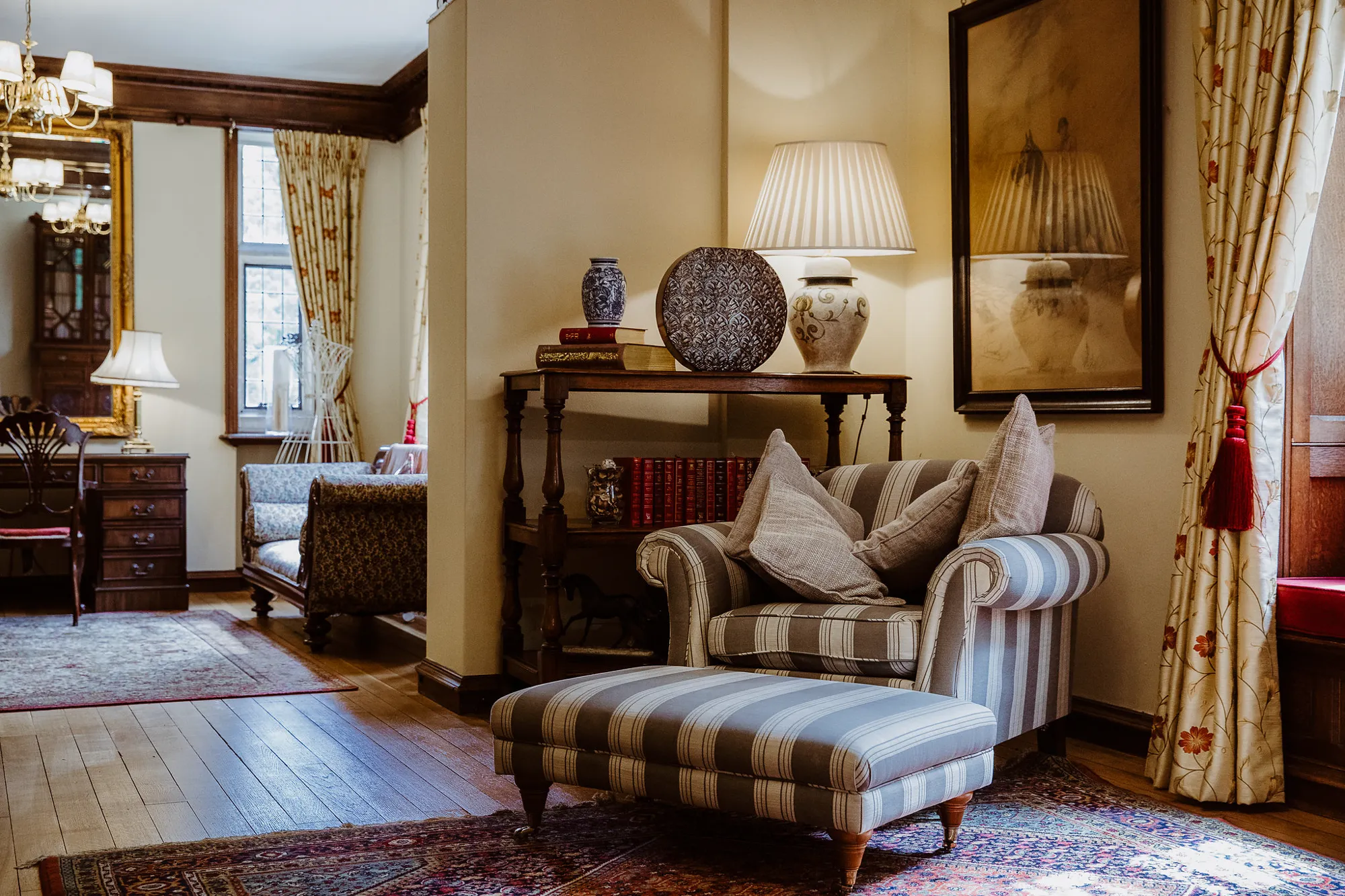 The Old Library at Lanwades Hall, a quiet room with sofas and antique furniture