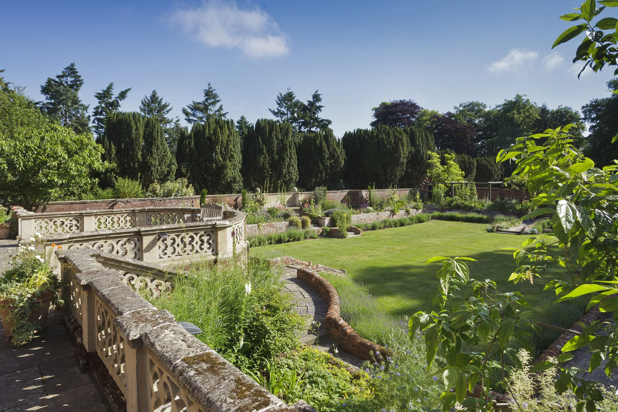 The terrace and sunken garden where guests relax across the weekend at Lanwades Hall