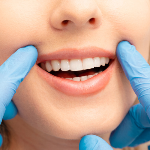 Dentist examining a patient's gums and teeth