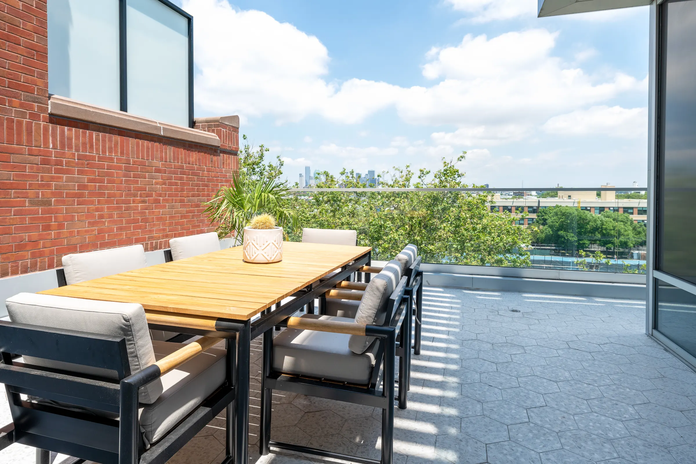 The suite's private terrace, with a long dining table and the skyline beyond