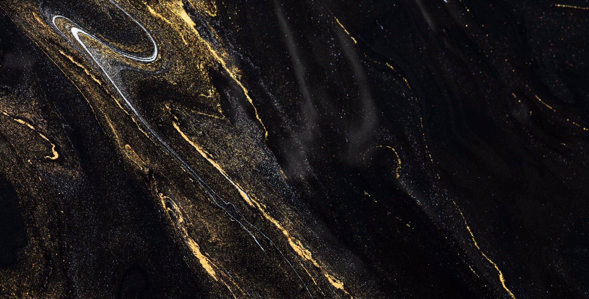 Abstract black marble texture with swirling gold and white veins creating an elegant, rich pattern.