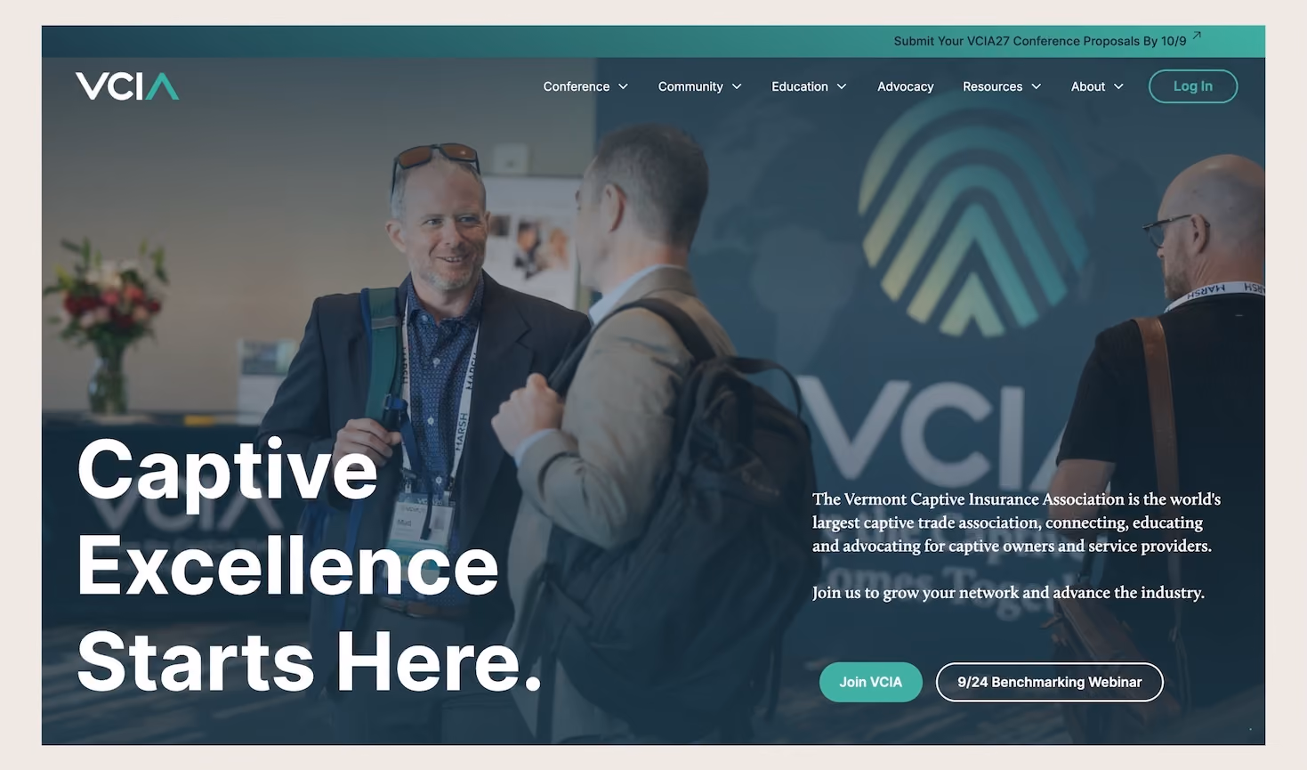 Website banner showing two men with conference badges conversing, with text 'Captive Excellence Starts Here.' and description of the Vermont Captive Insurance Association as the world's largest captive trade association, promoting connection, education, and advocacy for captive owners and service providers, alongside buttons labeled 'Join VCIA' and '9/24 Benchmarking Webinar.'