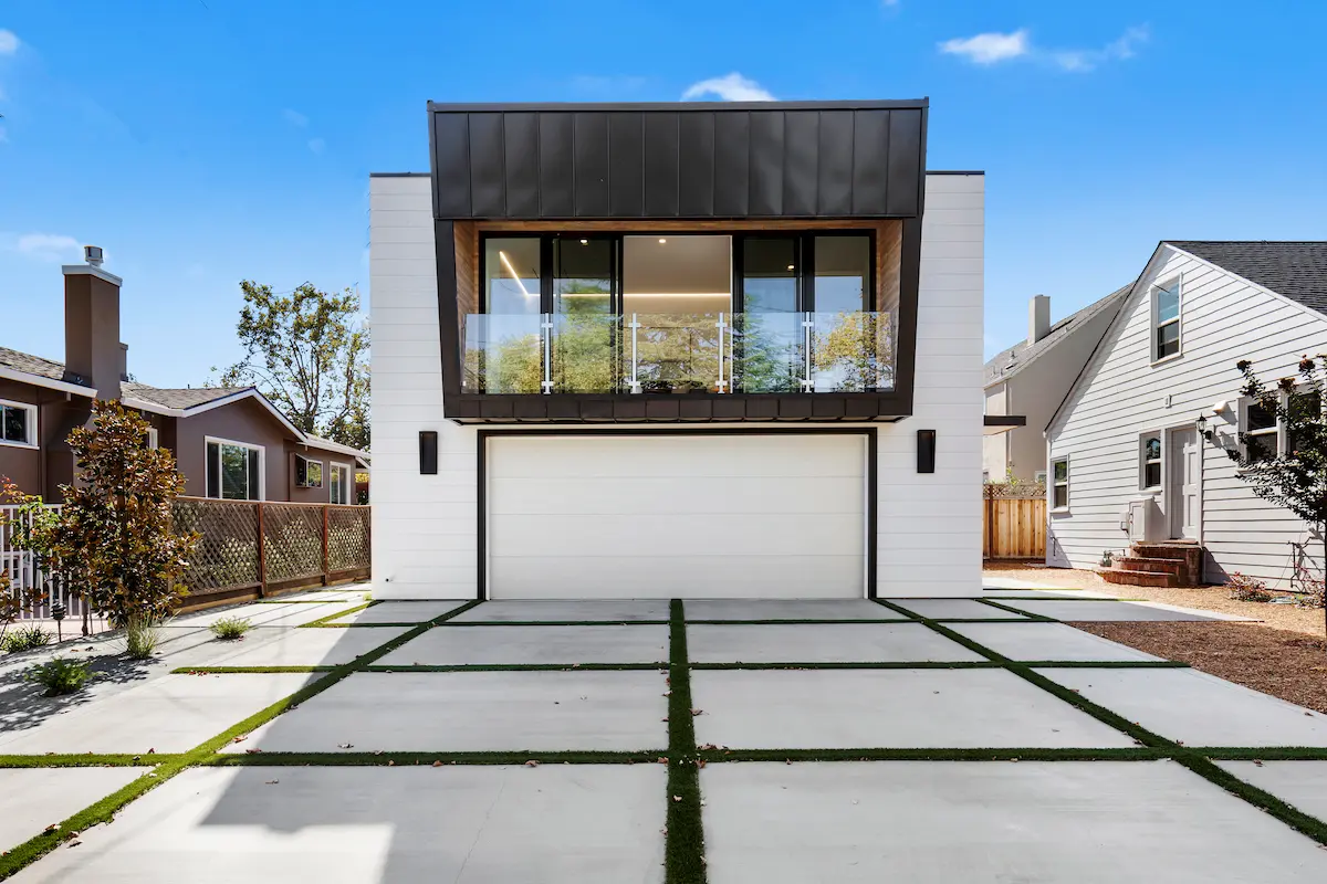 Lowell ADU with garage and sliding glass doors to a balcony. 