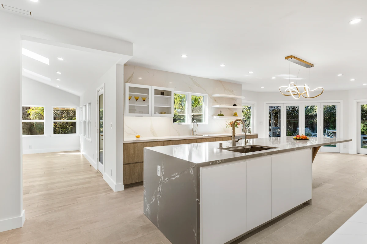 Greenwich remodel with a custom kitchen featuring a large island, statement lighting, and a double oven.