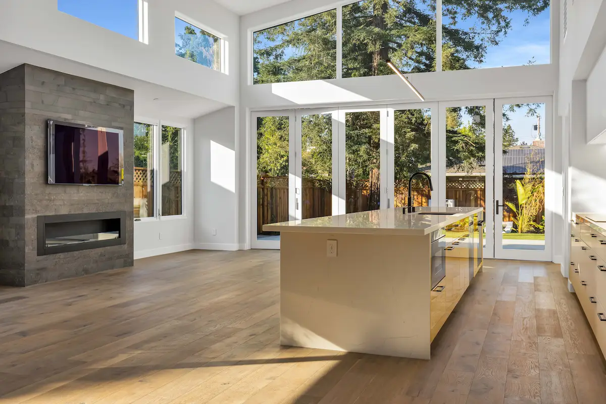 King St new build featuring a bright, contemporary living space with high ceilings, large windows, and a modern kitchen island.