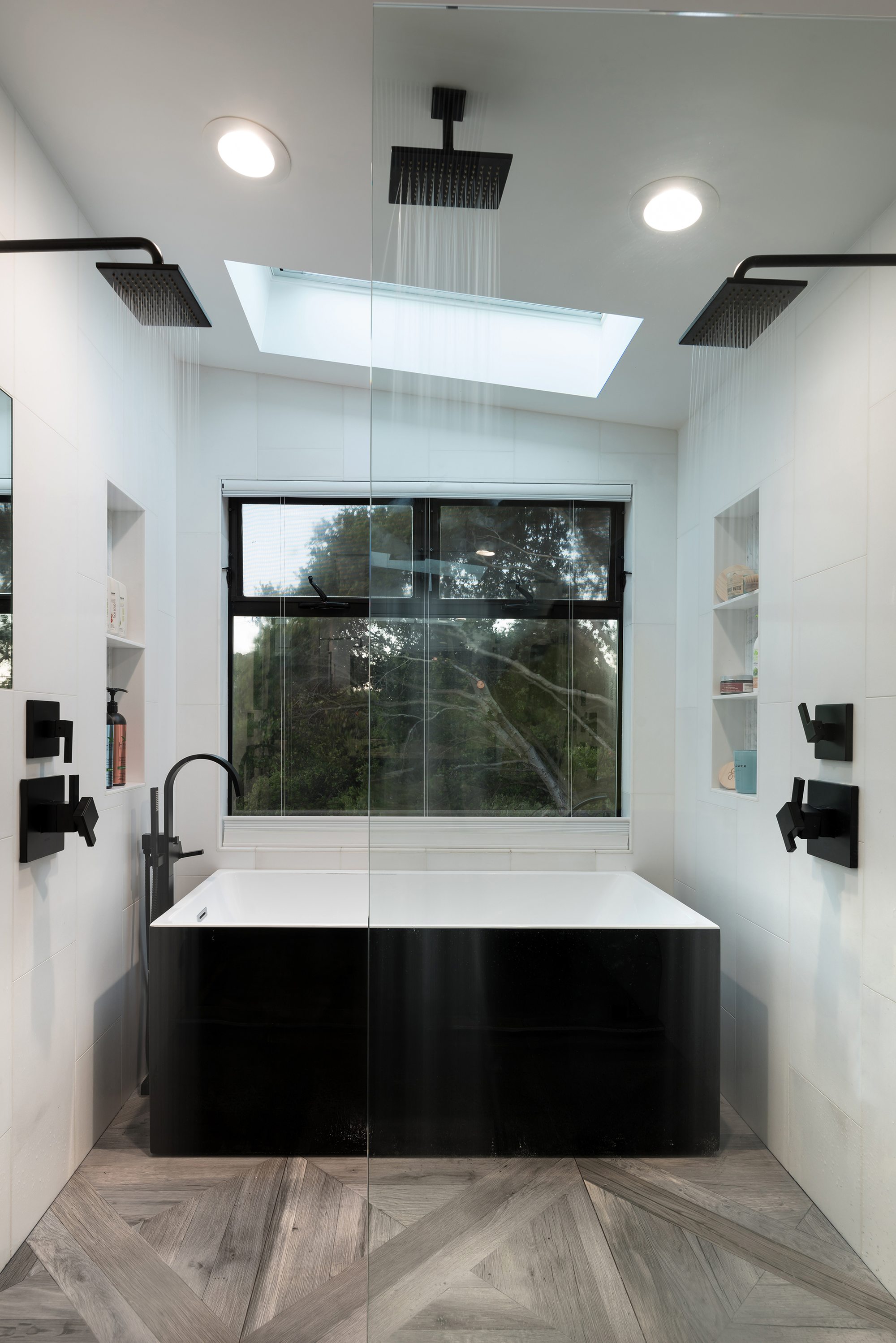 Thurm Avenue, a remodel in Belmont by Greenberg, the black tub beneath a skylight