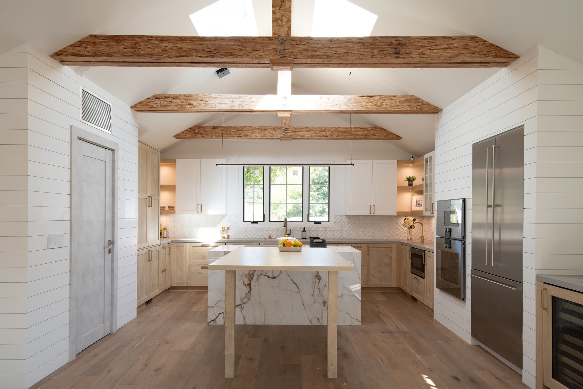 Springer, a remodel in Los Altos by Greenberg, the kitchen and island under the beams