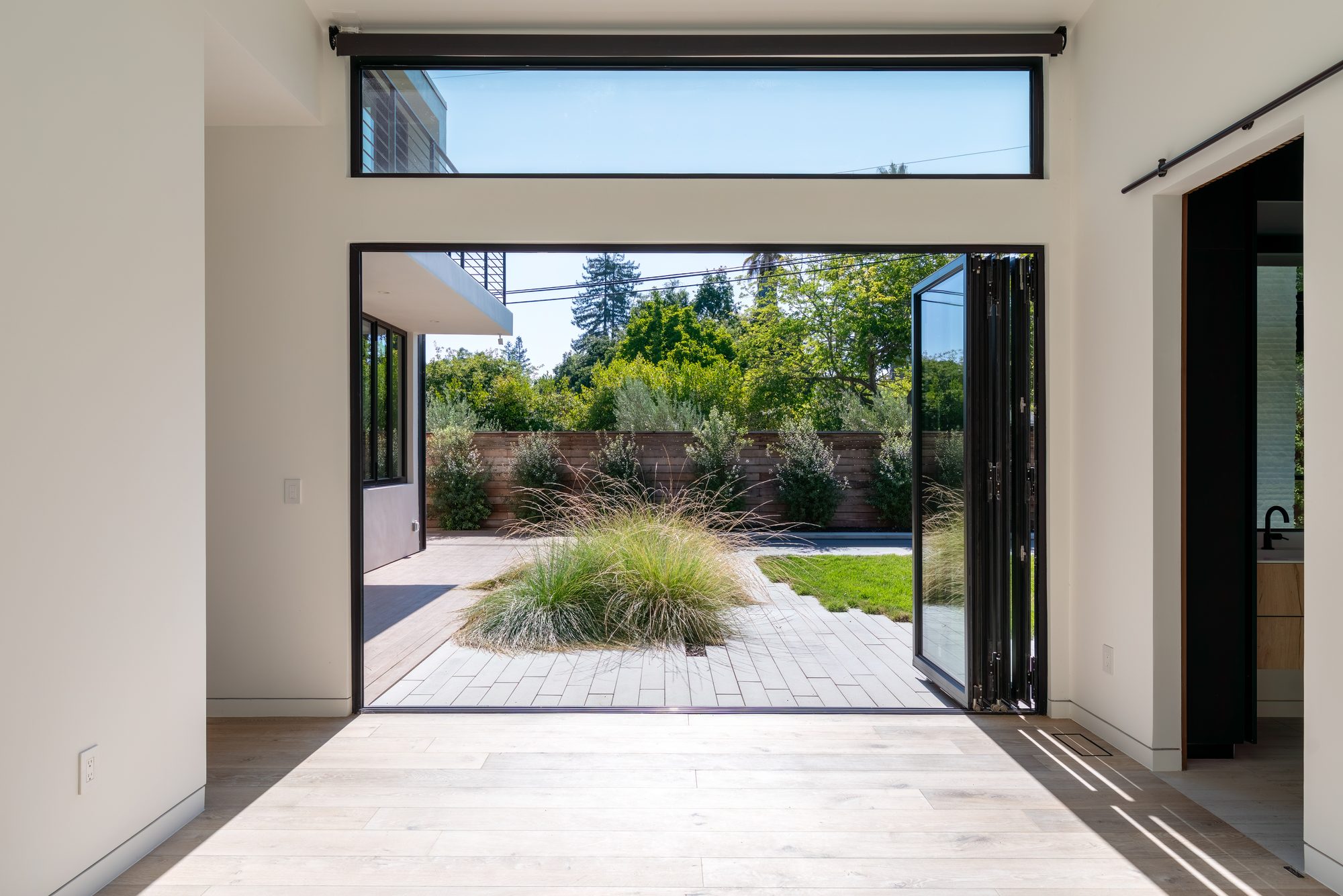 Stockbridge, a new build in Redwood City by Greenberg, the bifold doors open to the courtyard