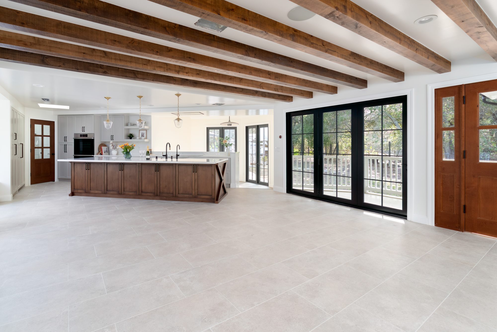 Pierce Rd, a new build in Saratoga by Greenberg, the great room and kitchen under exposed beams