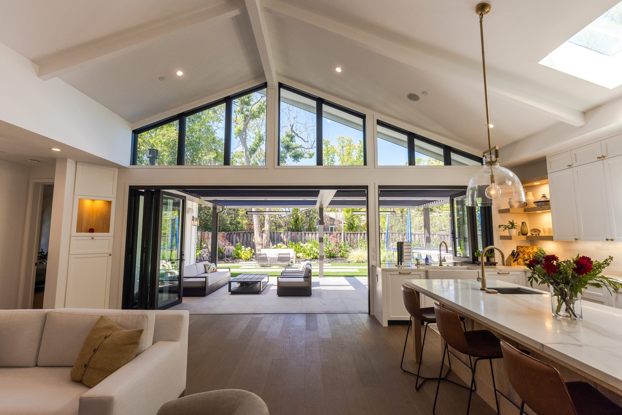 Golden Way, a new build in Los Altos by Greenberg, the living and dining rooms with the glass wall open