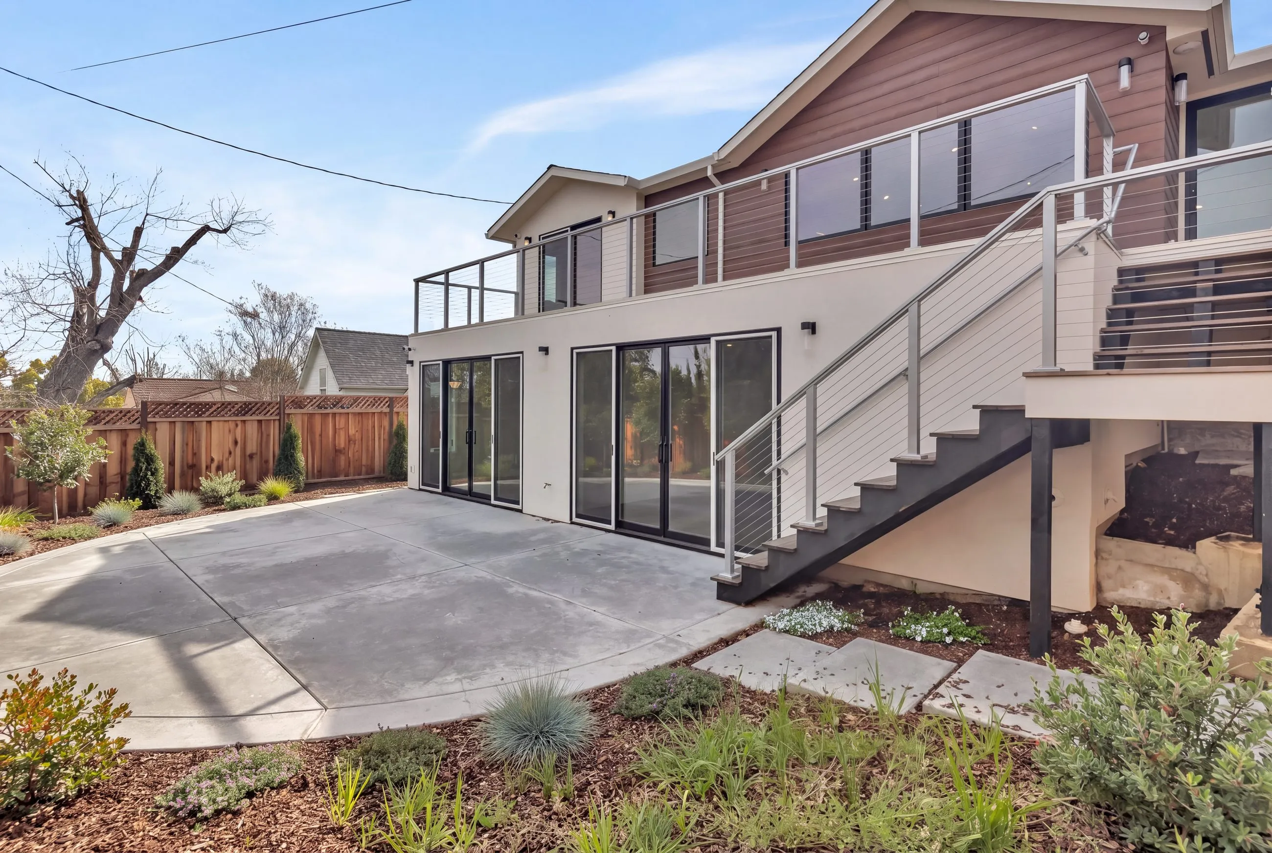 Westwood St remodel in Redwood City: rear elevation and deck above the patio, with landscaping rendered from the planting plan
