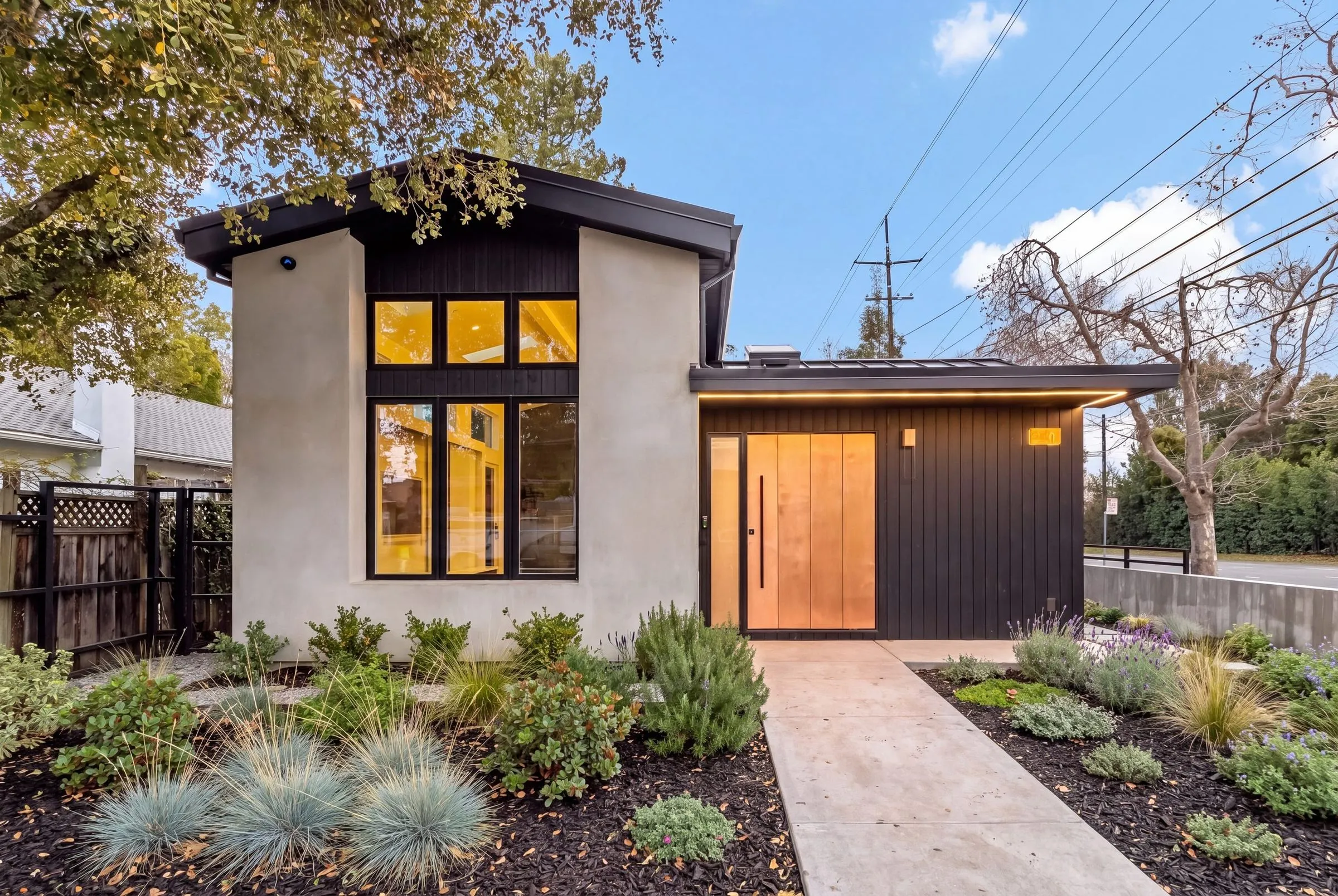 Santa Rita, a new build in Palo Alto by Greenberg, the front elevation at dusk with new planting along the walk