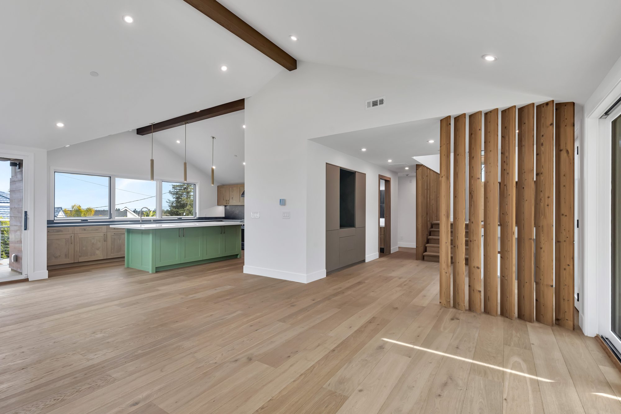 Westwood St, a remodel in Redwood City by Greenberg, the living space and kitchen behind the slat screen