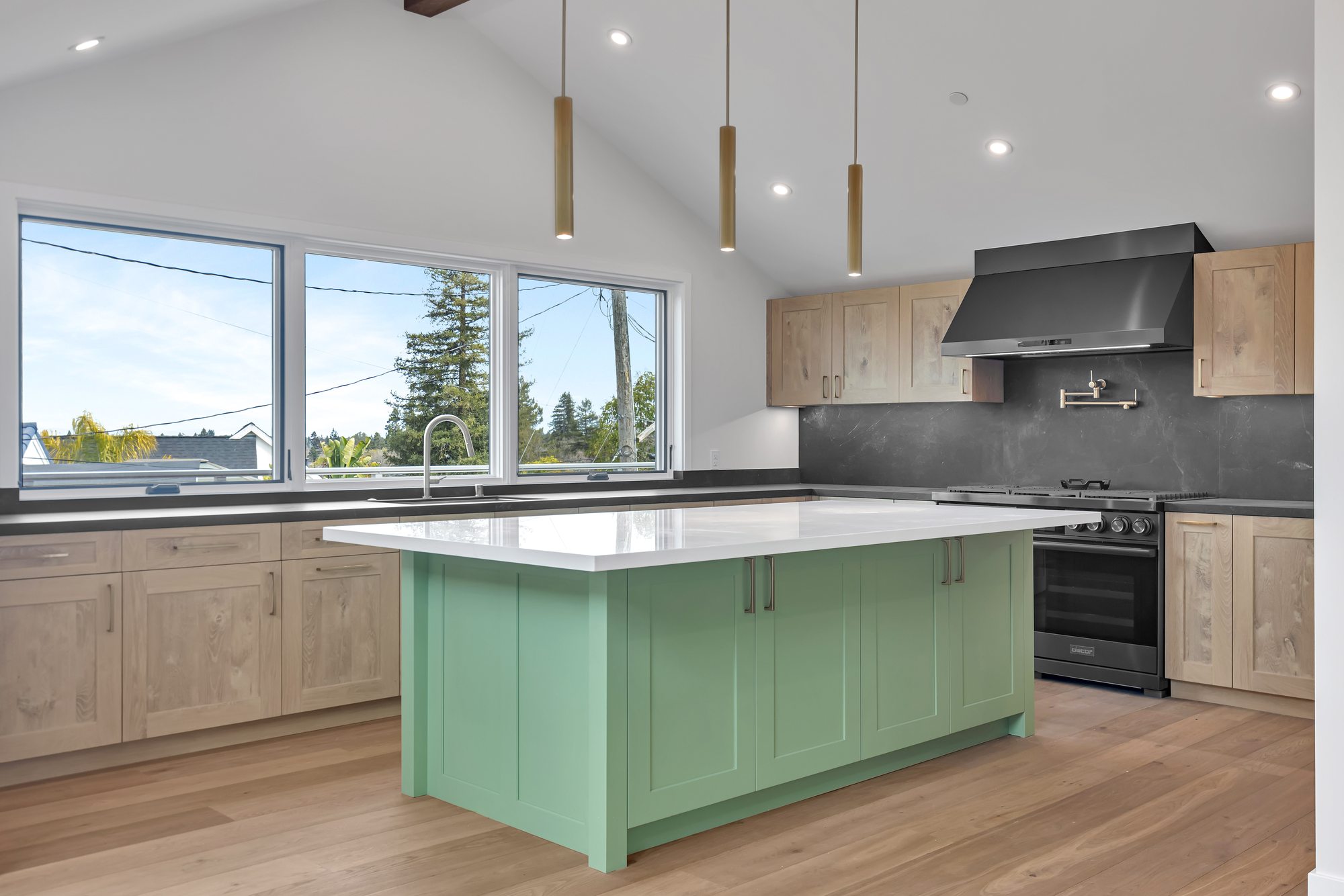 Westwood St, a remodel in Redwood City by Greenberg, the kitchen and its sage green island