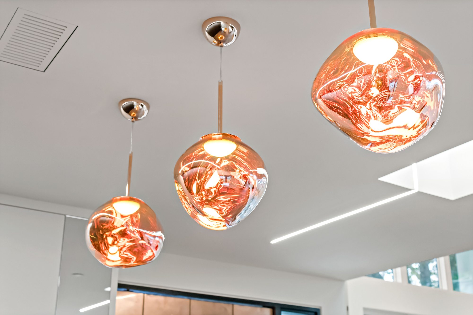 Santa Rita, a new build in Palo Alto by Greenberg, a cluster of copper blown-glass pendants
