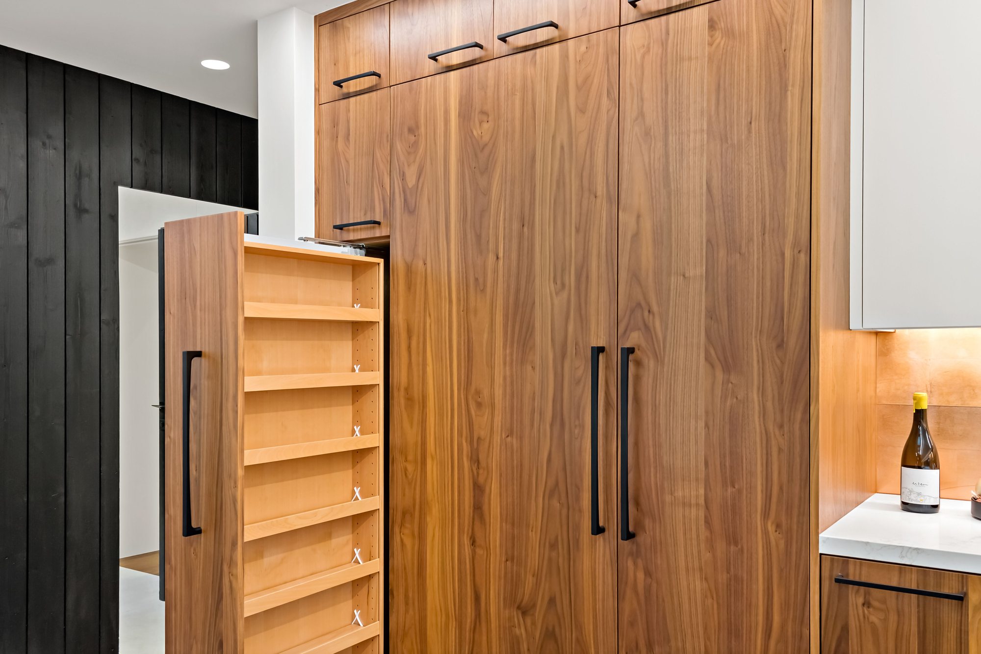 Santa Rita, a new build in Palo Alto by Greenberg, a walnut pantry with a pull-out rack