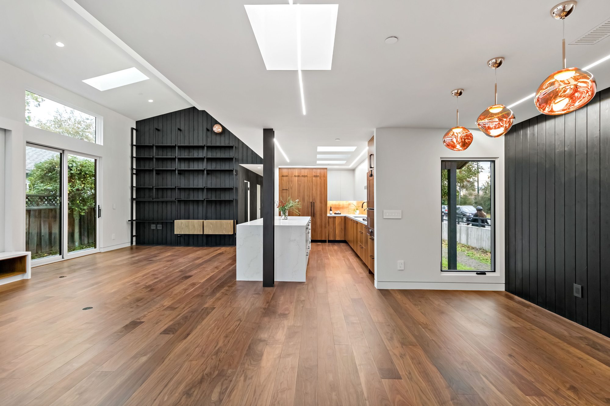 Santa Rita, a new build in Palo Alto by Greenberg, the open living and dining area beside a black shiplap wall