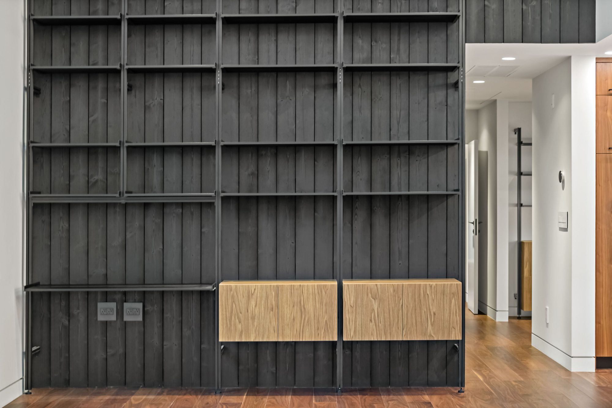 Santa Rita, a new build in Palo Alto by Greenberg, a black shiplap wall with oak-front shelving