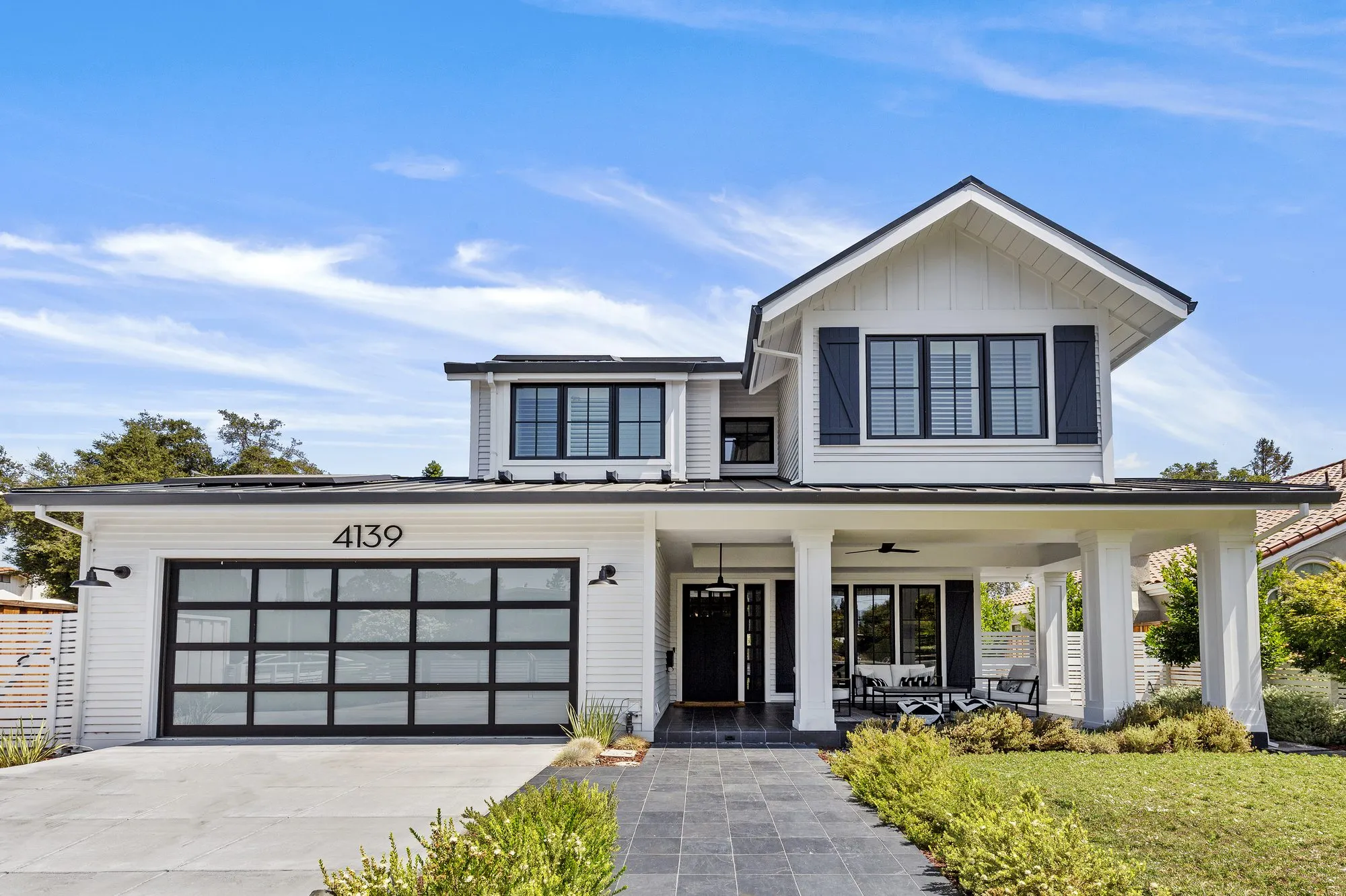 Front exterior of Greenberg’s Amaranta Avenue new-build home in Palo Alto, with a covered porch and landscaped entry
