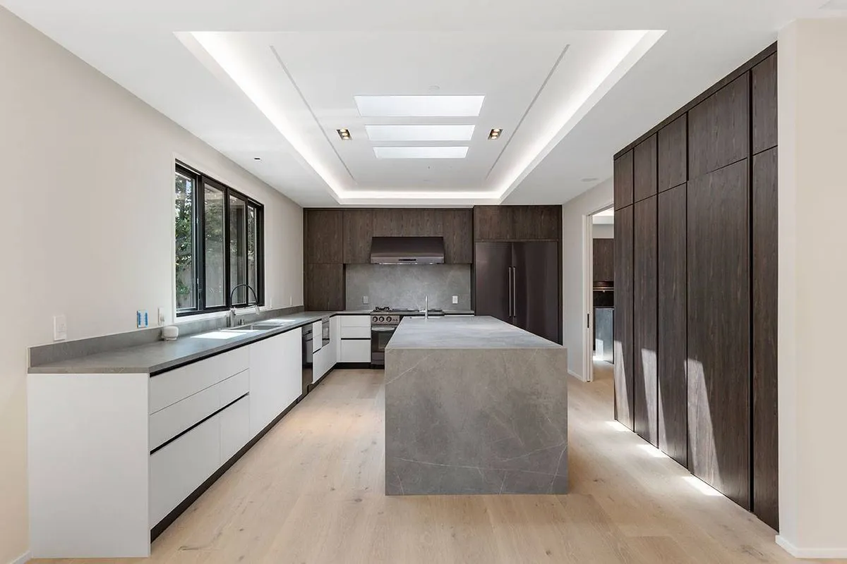 Stone countertops and a full height slab in a finished Greenberg kitchen