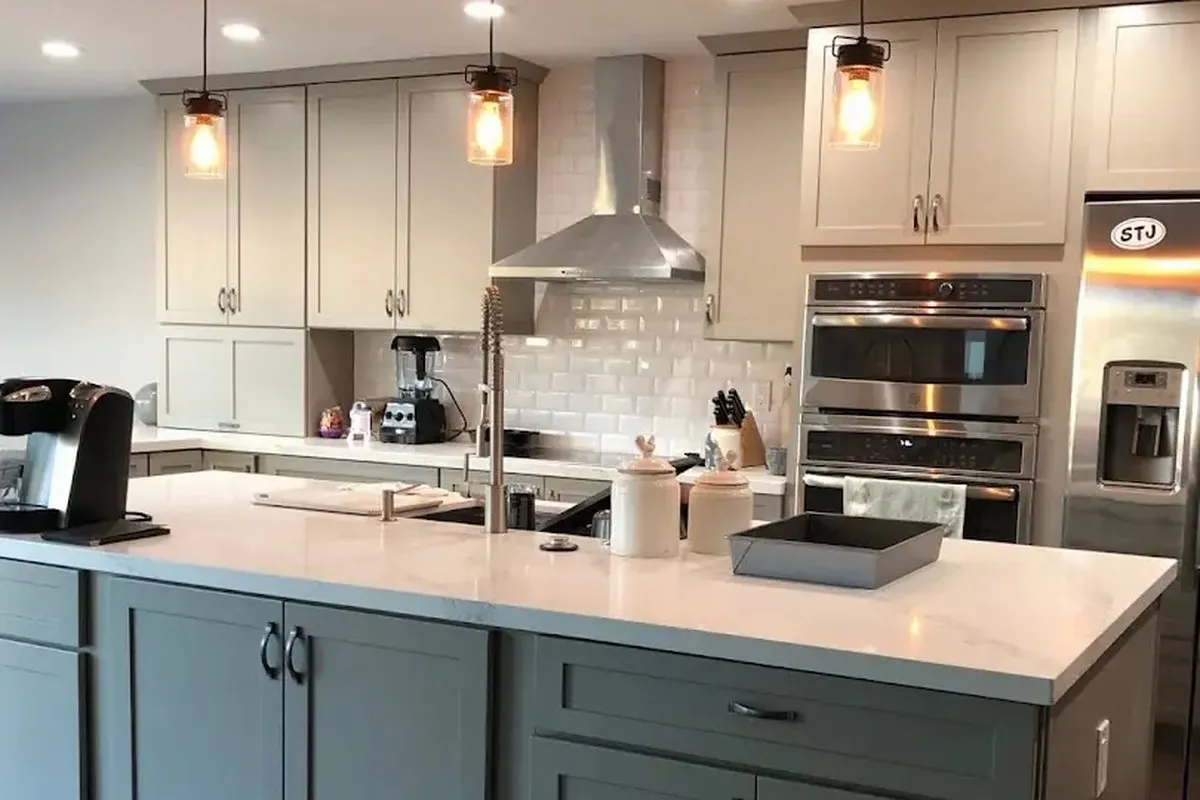 Pendant fixtures lit over an island in a finished Greenberg kitchen