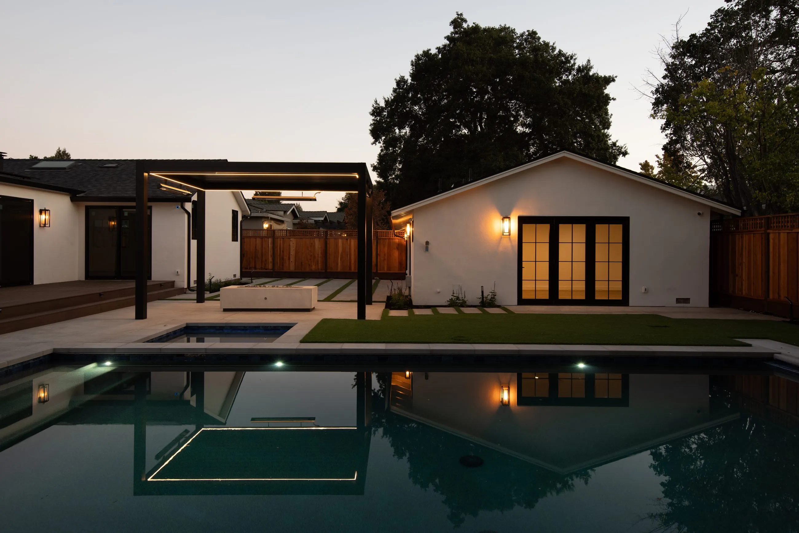 Springer, a whole-house remodel and addition in Los Altos by Greenberg, the pool terrace at dusk