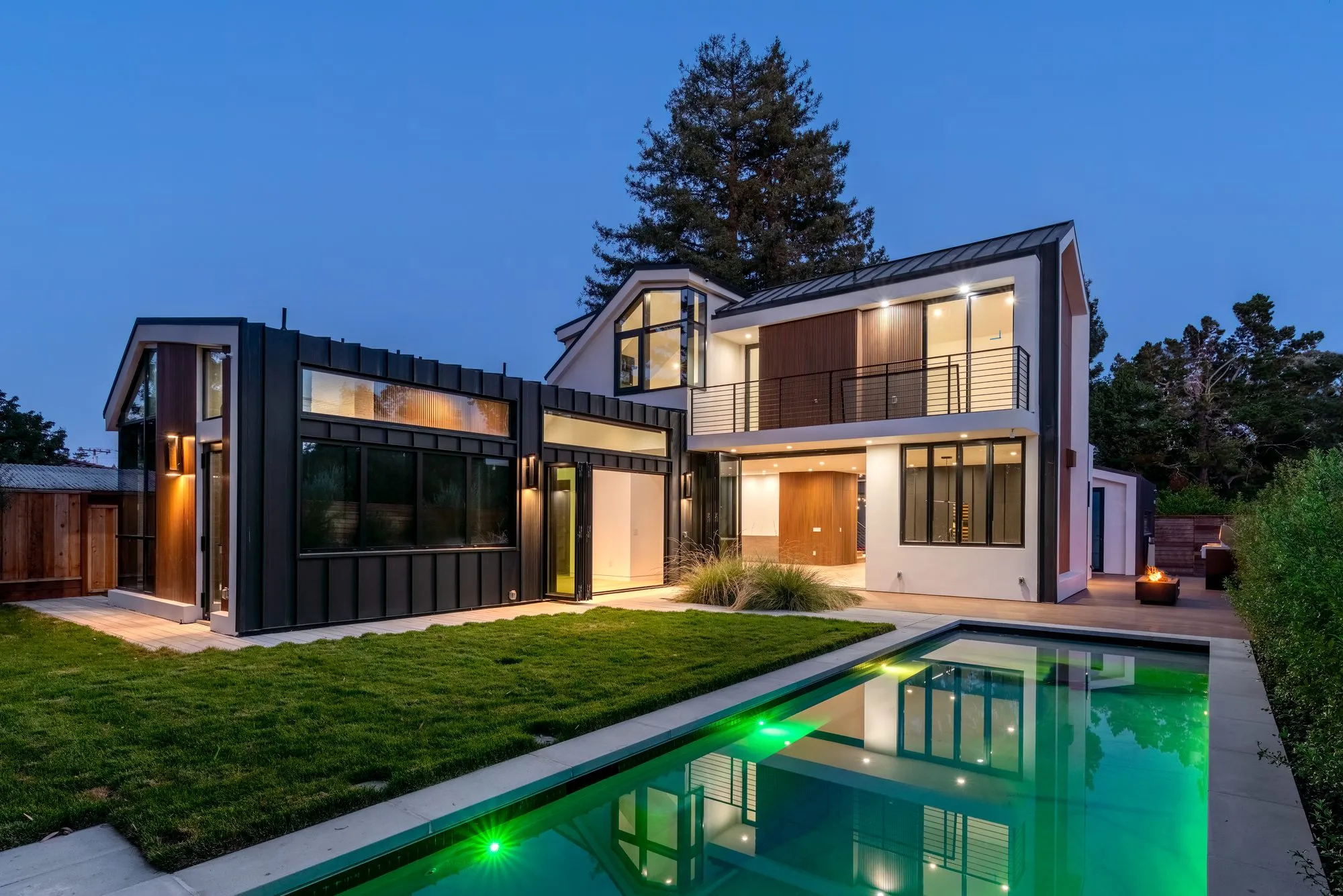 Stockbridge, a new build in Atherton by Greenberg, the rear elevation and pool at dusk