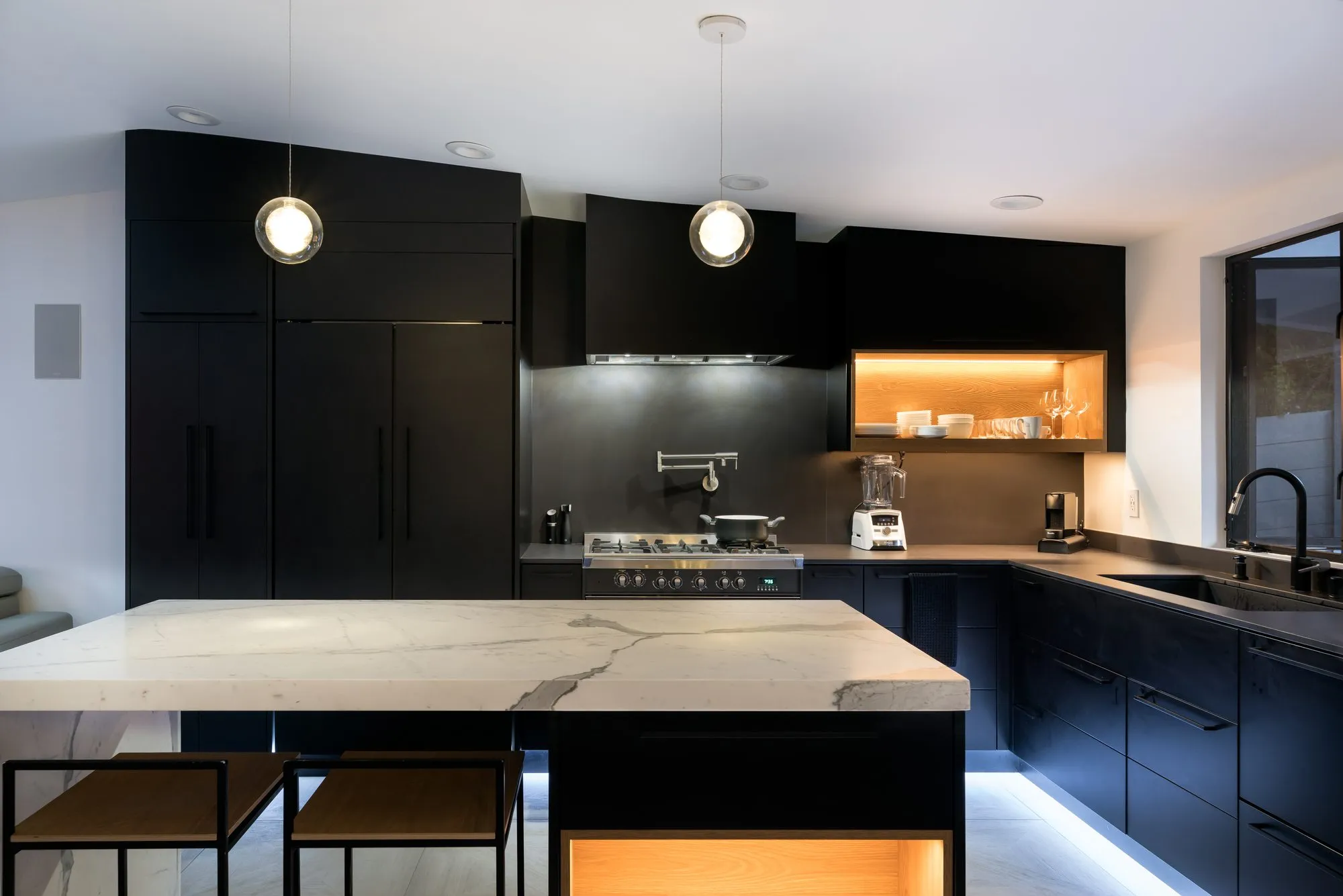 Thurm, a remodel in Belmont by Greenberg, the black kitchen with marble island