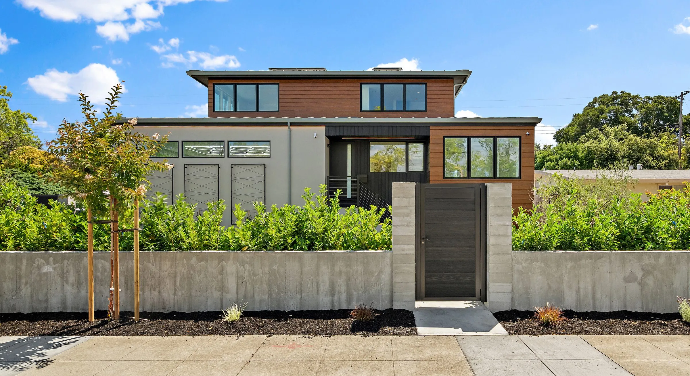 Ross Rd, a new Greenberg home in Palo Alto, the front elevation behind its concrete garden wall and gate