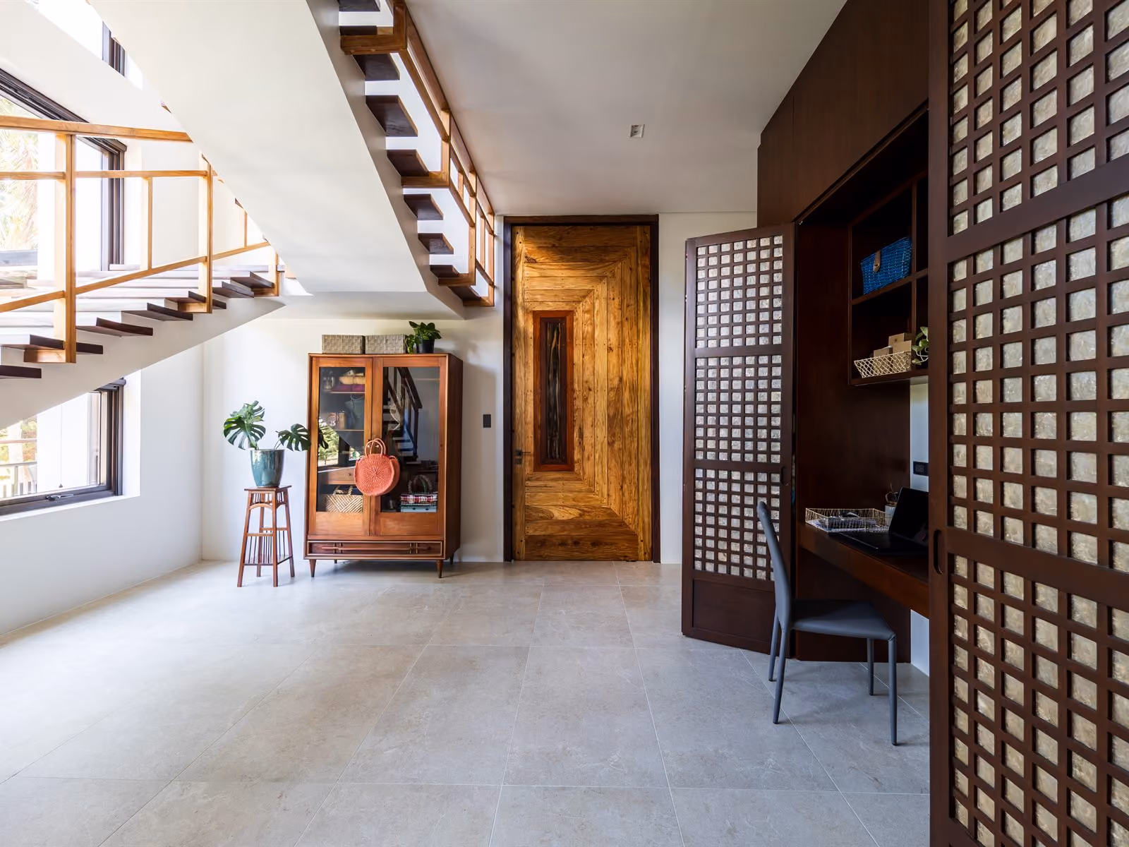 stairs to the upper suites, office behind capiz screens