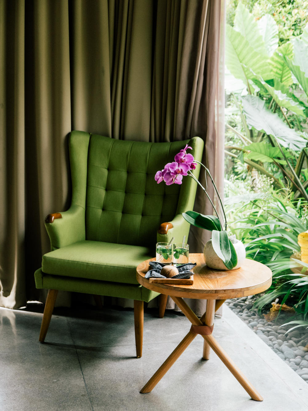Green armchair and orchid in the suite corner
