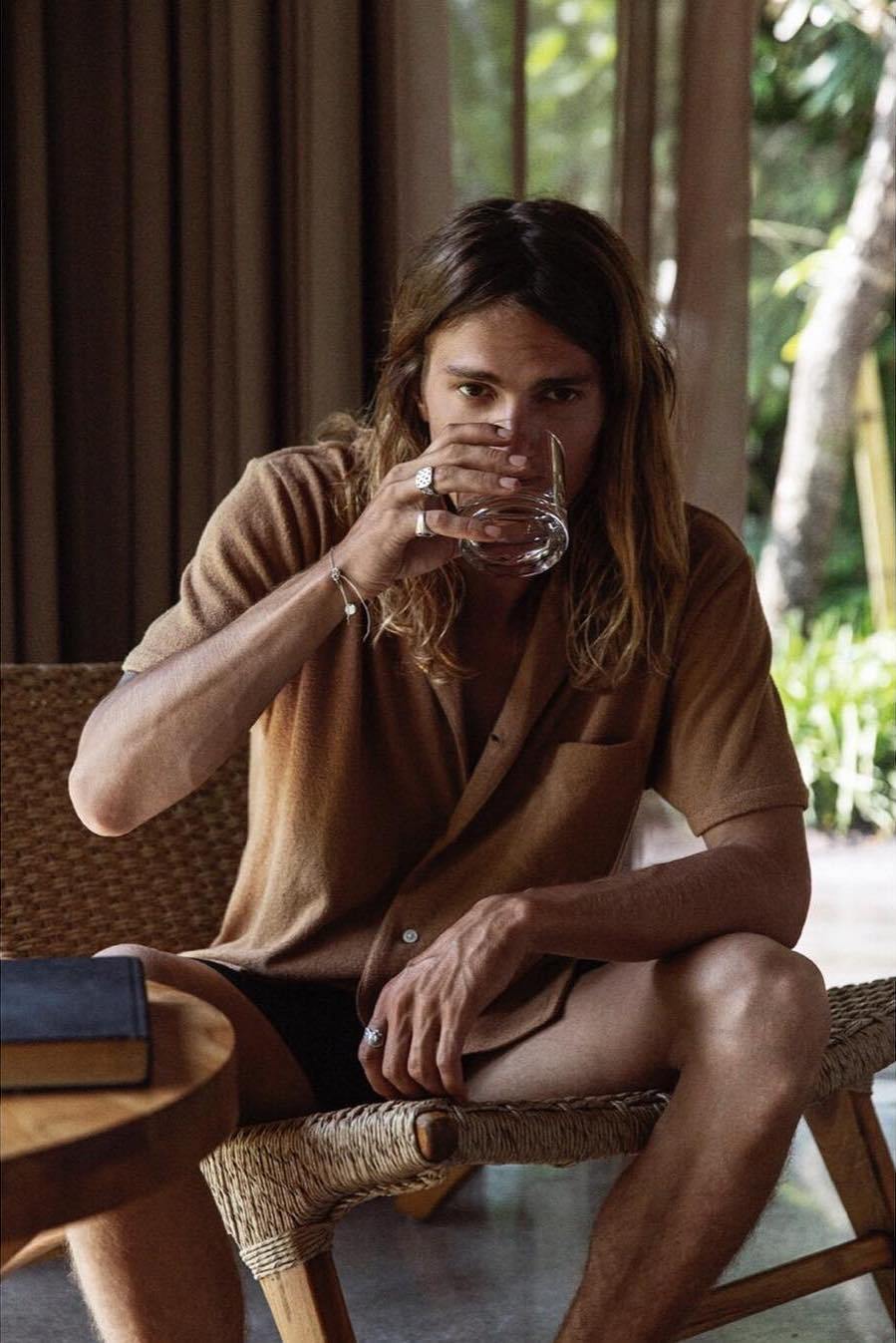 Guest with a morning drink in the pavilion
