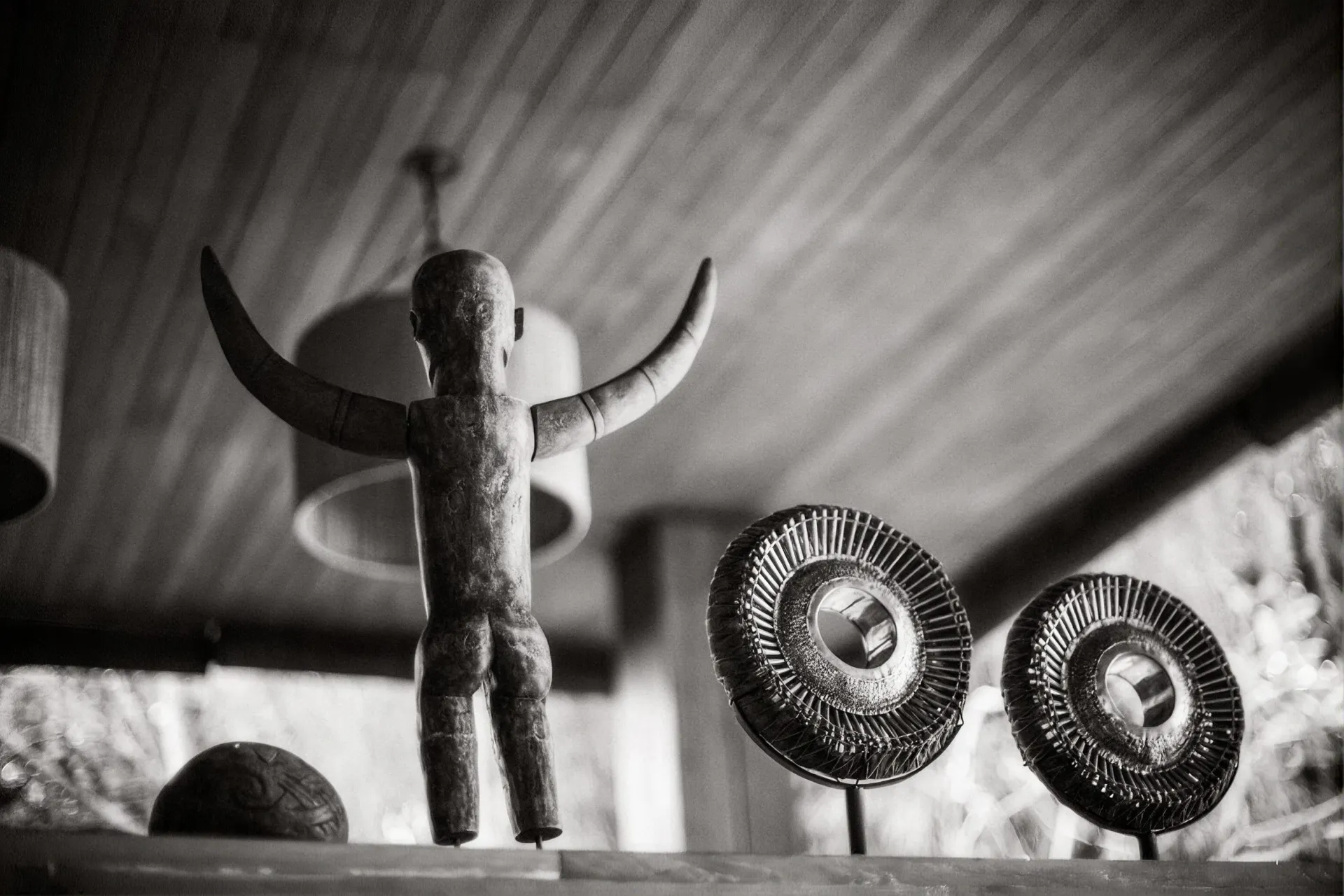 Carved figure and antique fan against the stone wall