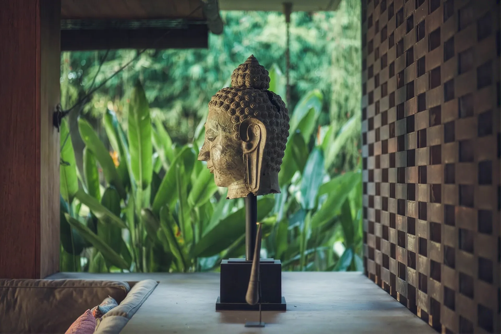 Carved Buddha head among the greenery