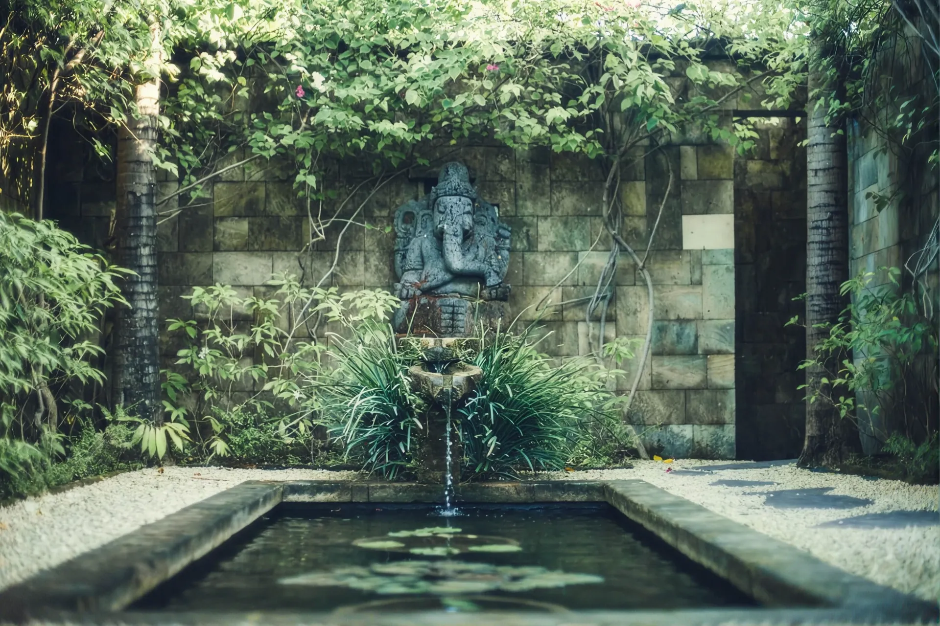 Stone deity above the garden water feature
