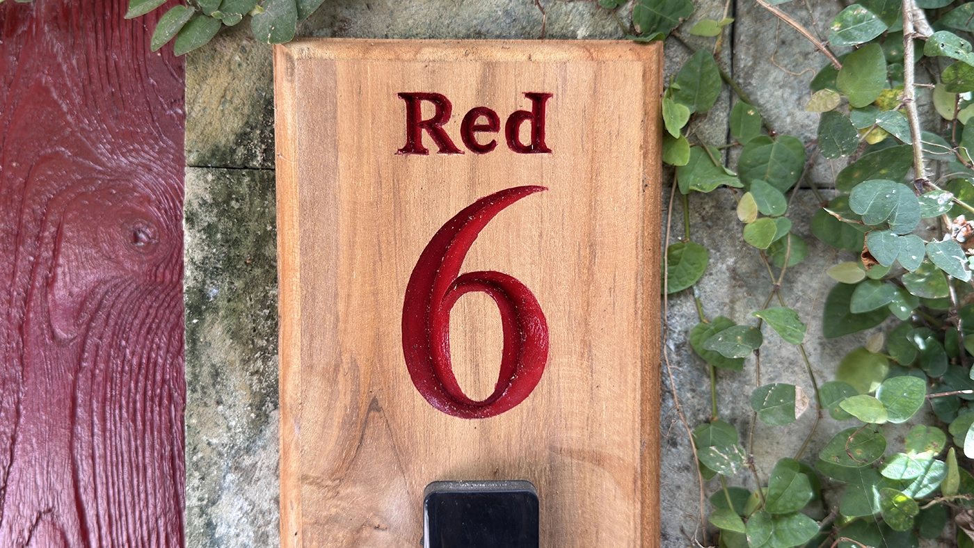 Carved "Red 6" sign at the villa gate
