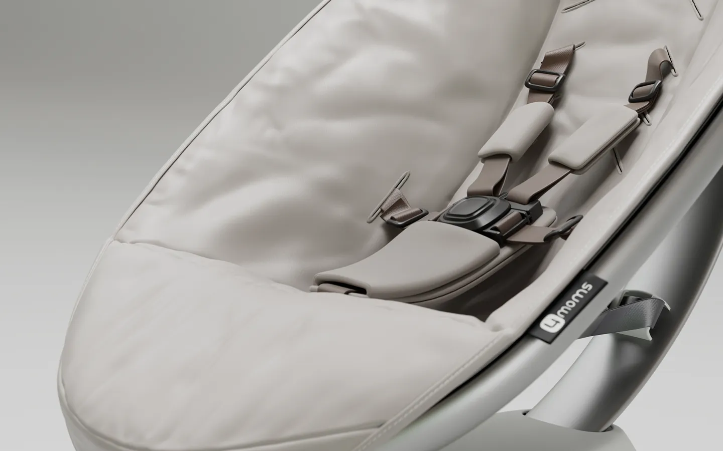 Close-up of a beige padded 4moms baby seat with a five-point safety harness