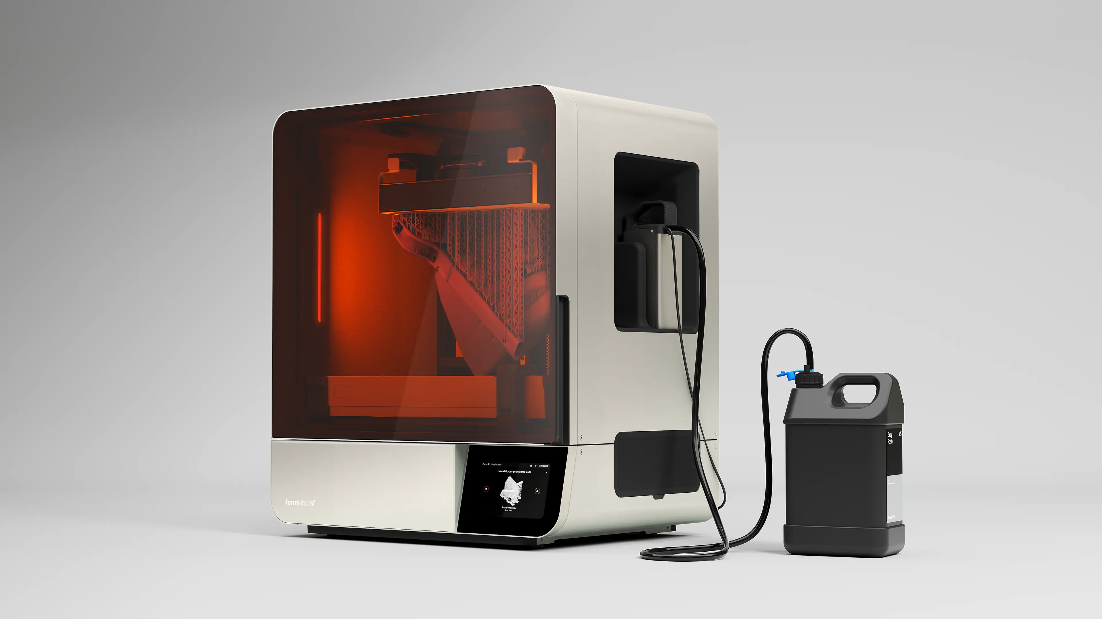 A white Formlabs 3D printer with a translucent orange cover showing a 3D printed object being formed inside, connected by a black tube to a black resin container with a blue valve on top.