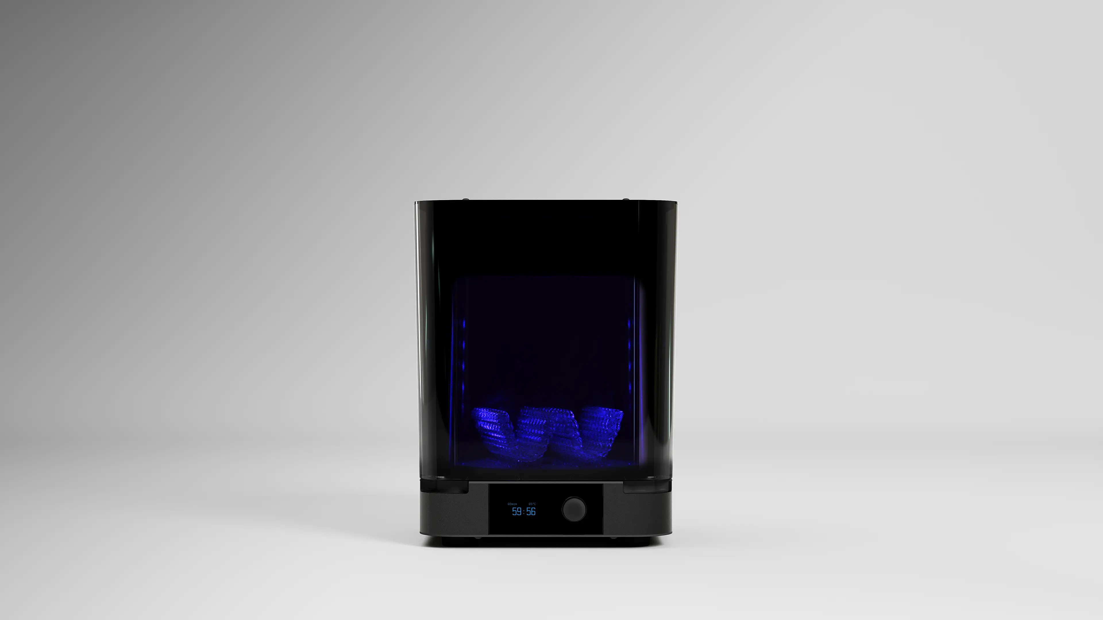 Black resin 3D printer with blue internal lights showing a partially printed object inside, placed on a white surface with a plain gray background.