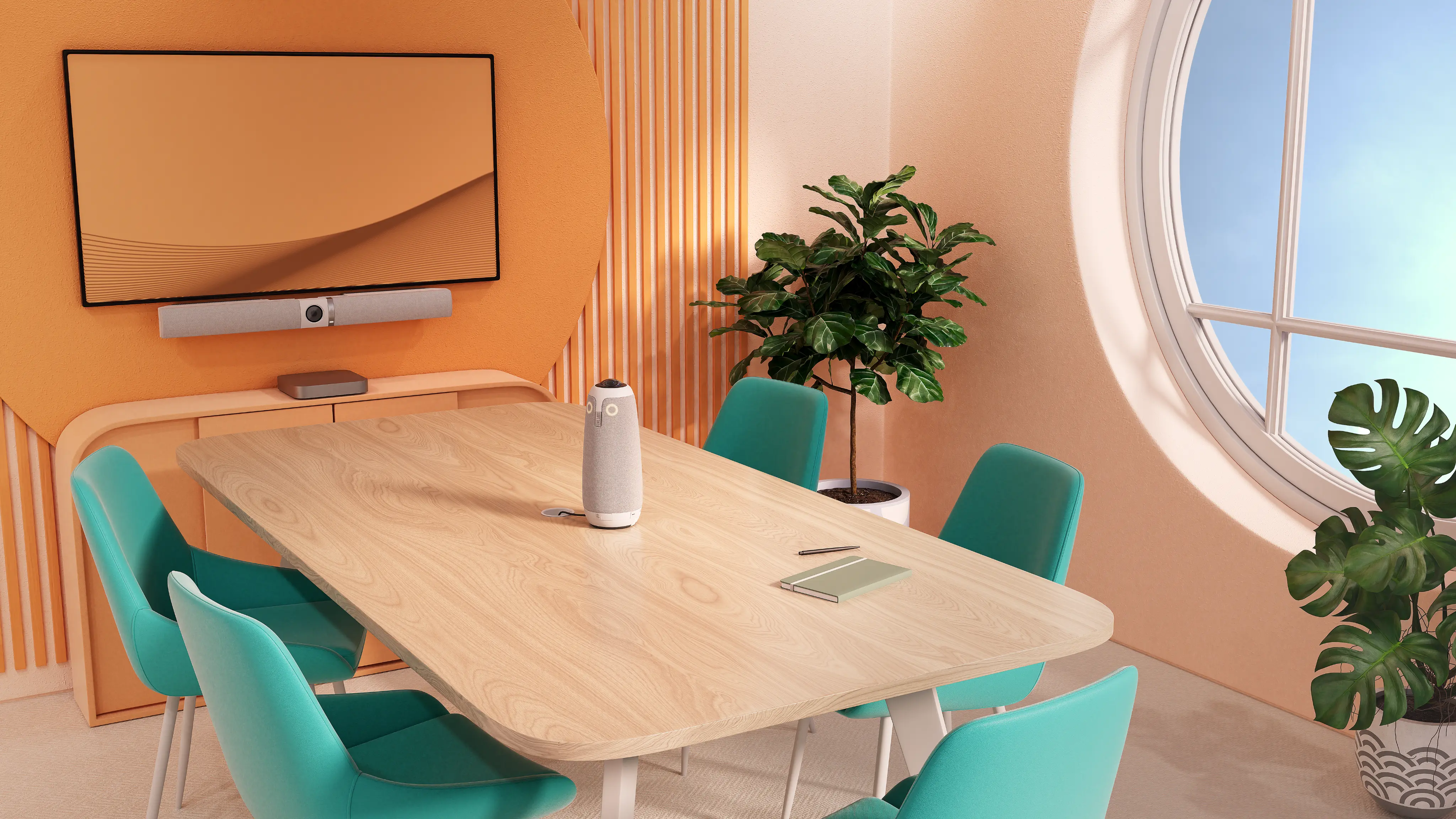 Modern conference room with a light wood table surrounded by six teal chairs, a gray owl-shaped speaker on the table, a notebook and pen, an orange accent wall with a mounted flat-screen TV and soundbar, large round window letting in natural light, and green potted plants.