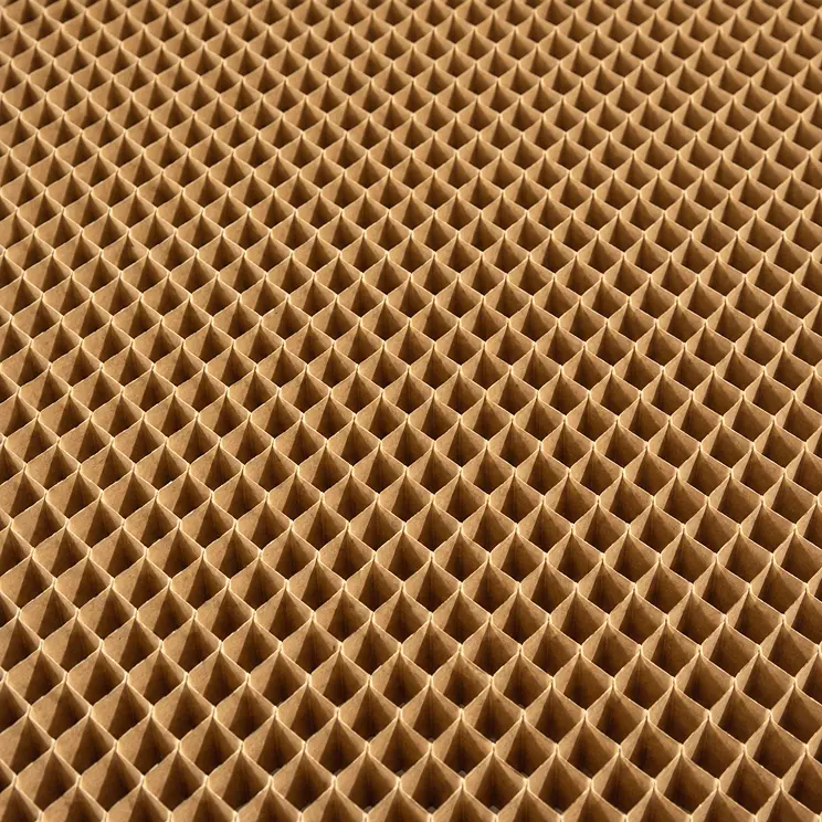 Close-up view of a honeycomb structure made of brown cardboard or paper, showing a repeating pattern of hexagonal cells.