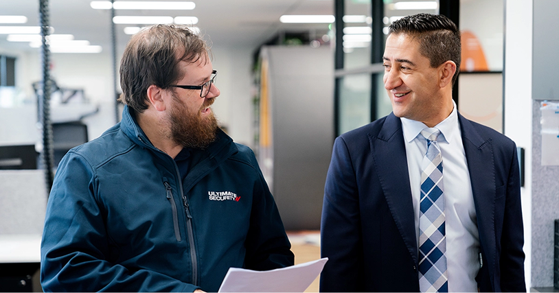 Ultimate Security chief executive talking with an employee during an office walkthrough