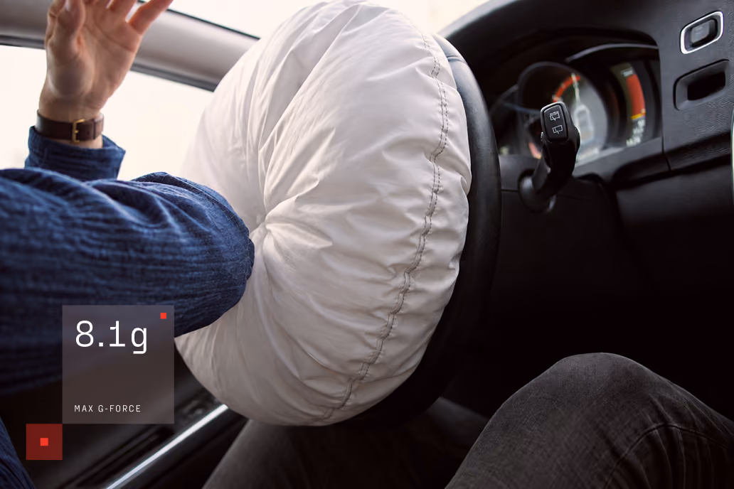 Person gripping a car steering wheel tightly, with an inset showing a max G-force of 8.1g during a drive.
