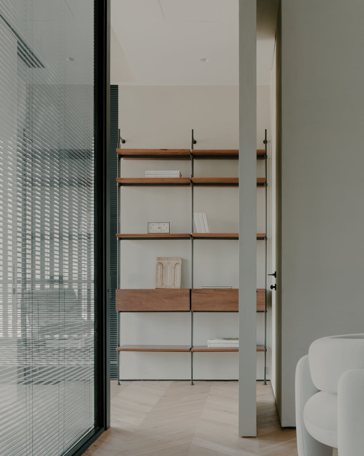 Reeded glass partition beside open timber shelving
